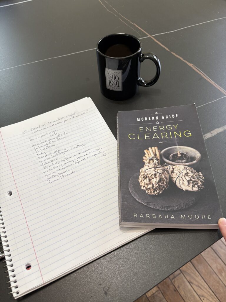 notebook and book on table with a cup of coffee