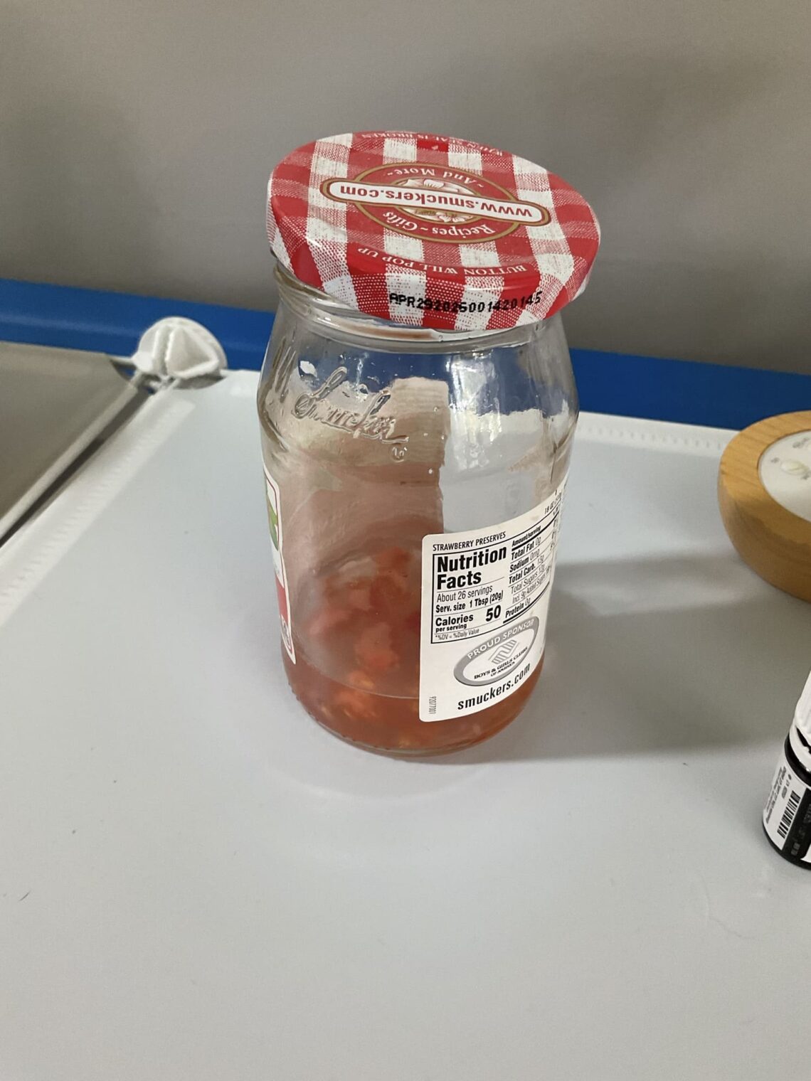 jelly jar of tomato seeds in water