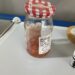 jelly jar of tomato seeds in water